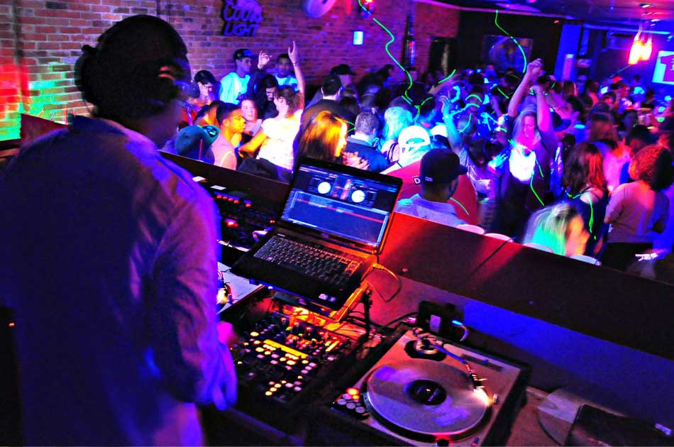 DJ performing at a crowded neon night party in Weston, FL